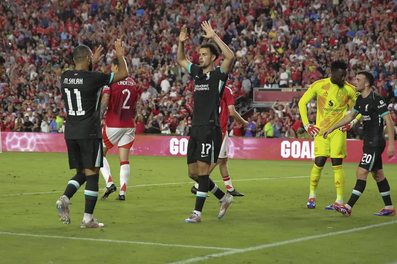 Liverpool midfielder Curtis Jones celebrates his goal with forward Mohamed Salah