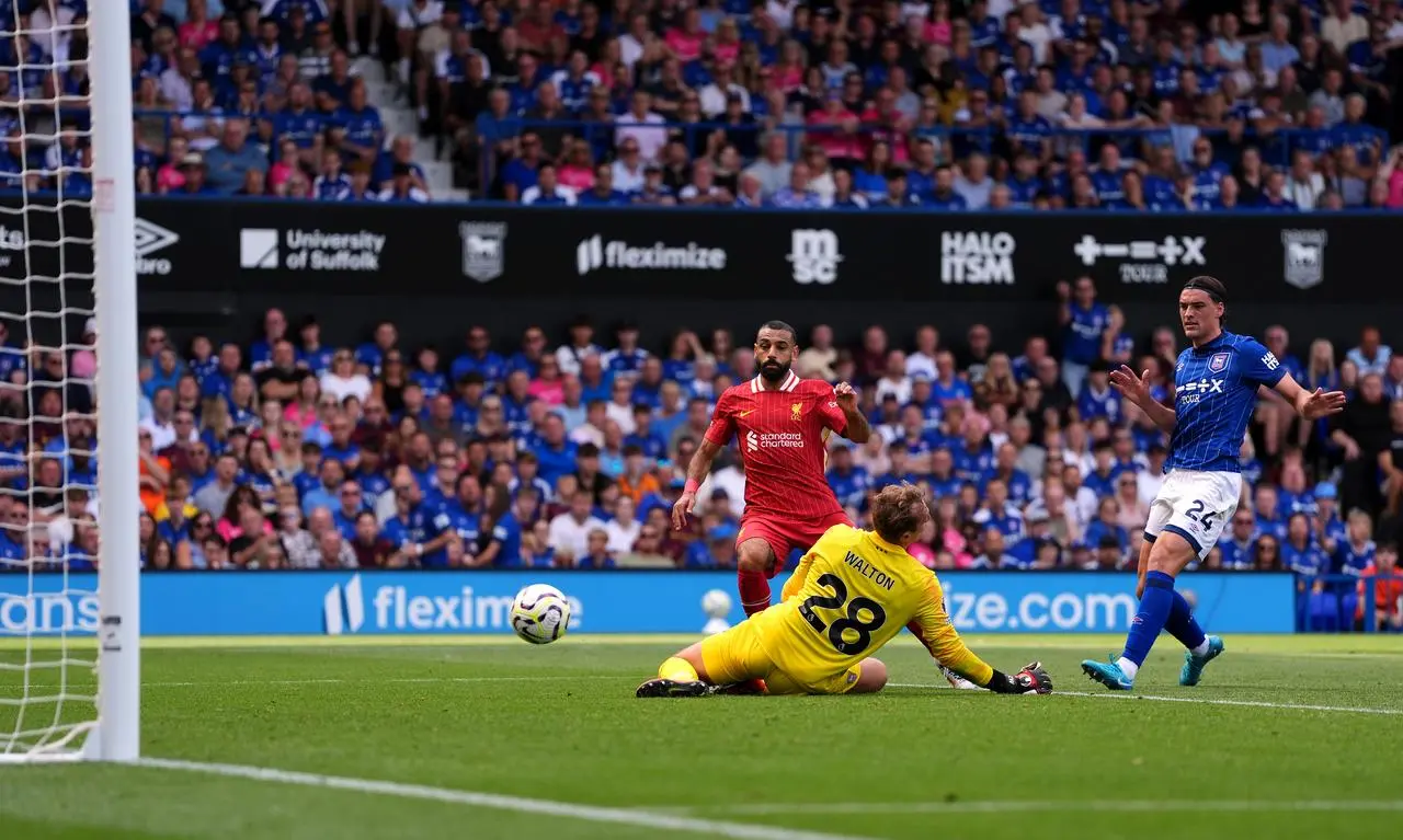 Mohamed Salah, left, scores Liverpool’s second goal as Ipswich keeper Christian Walton dives at his feet