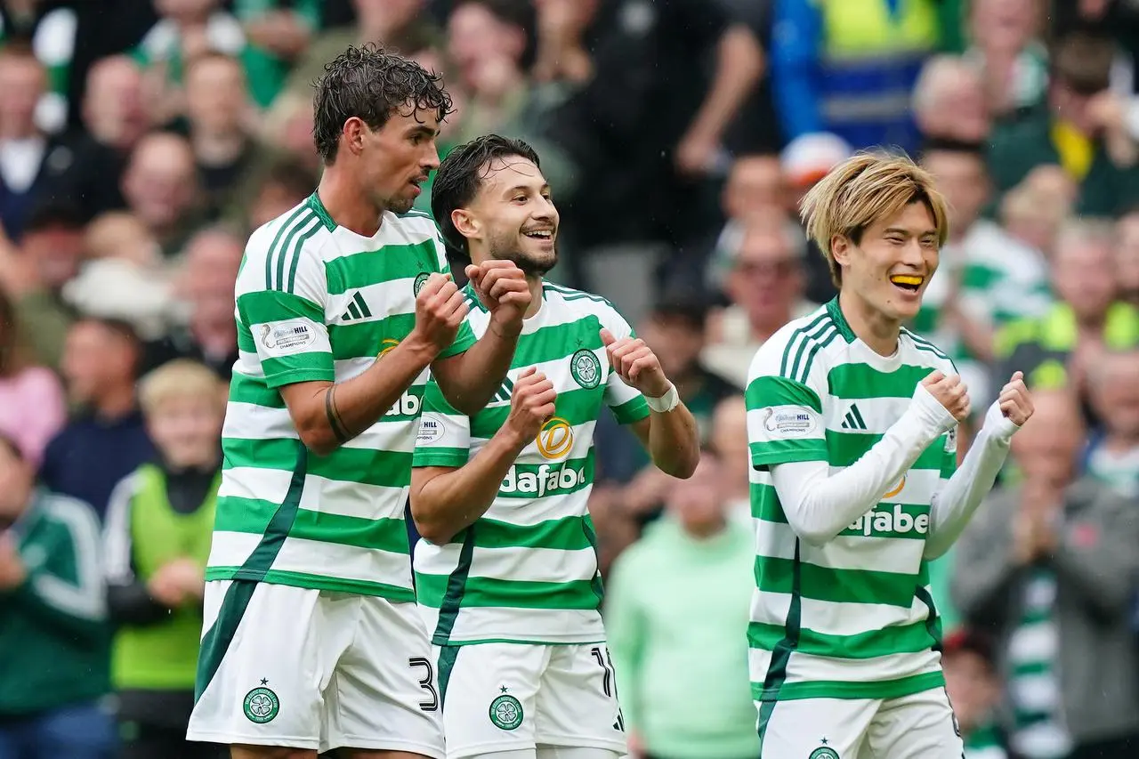 Matt O'Riley, left, Nicolas Kuhn, centre, and Kyogo Furuhashi do a celebratory dance after a Celtic goal against Kilmarnock