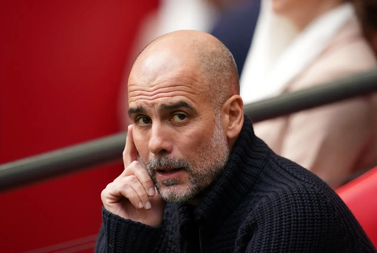 Pep Guardiola watches from the dugout