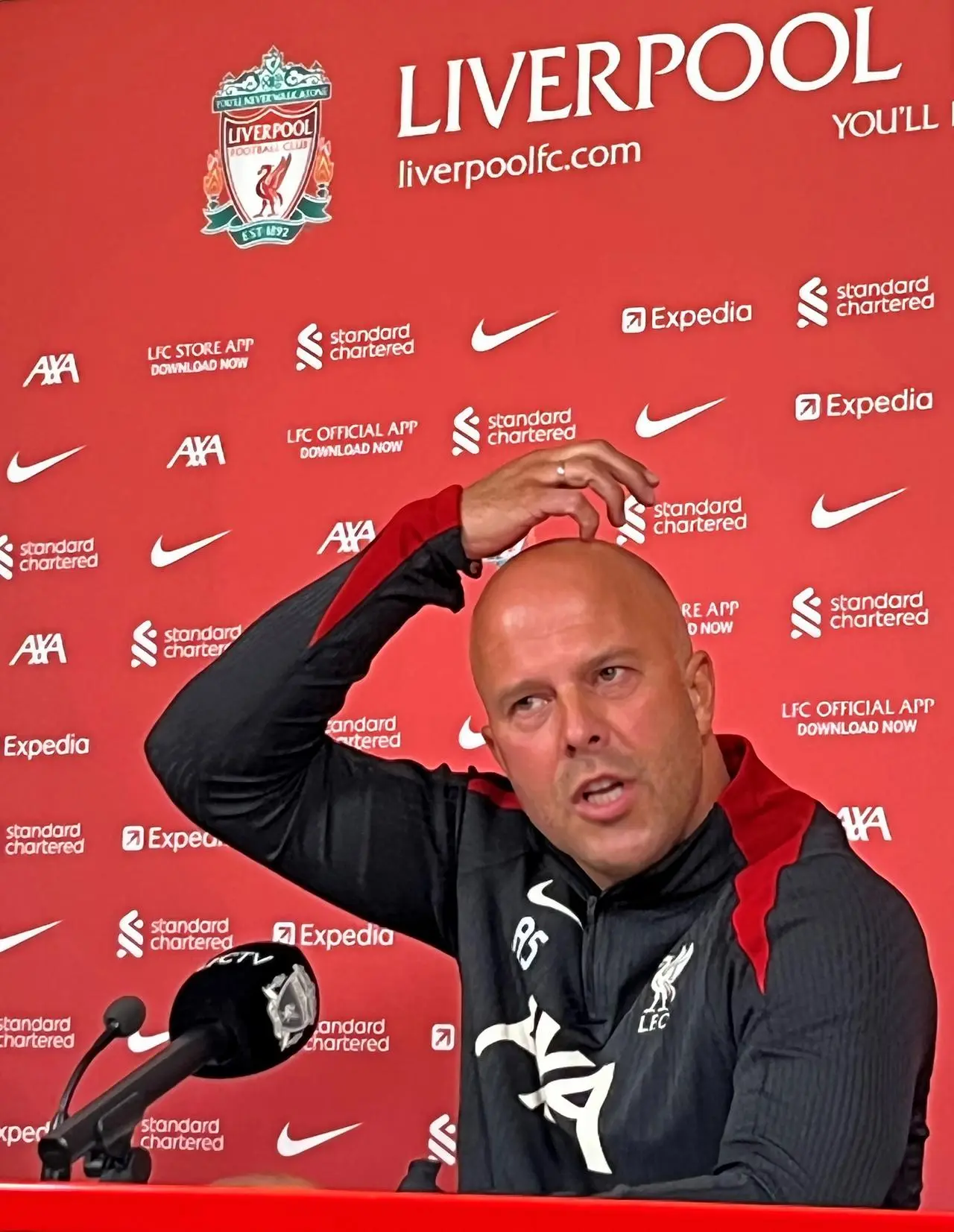 Liverpool head coach Arne Slot scratches his head during a press conference