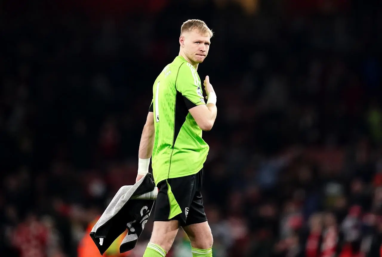 Arsenal goalkeeper Aaron Ramsdale walks off the pitch carrying a towel