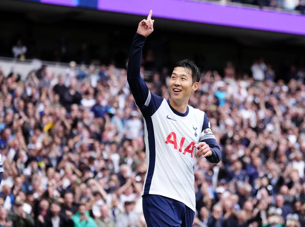 Son Heung-Min holds his right arm up to celebrate scoring for Tottenham against Everton