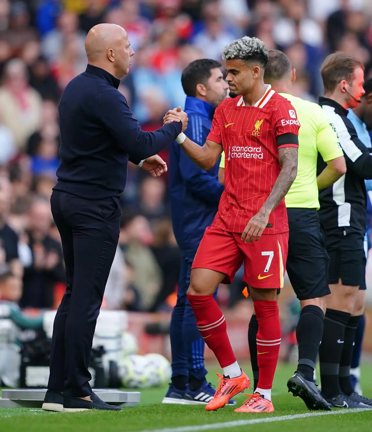 Arne Slot, left, clasps hands with Luis Diaz after substituting him off against Nottingham Forest