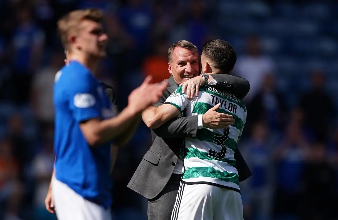 Brendan Rodgers hugs Greg Taylor 