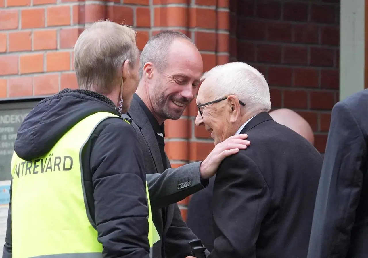 Sven-Goran Eriksson’s father Sven, right, and son Johan greet each other outside Fryksande Church at the former England manager's funeral