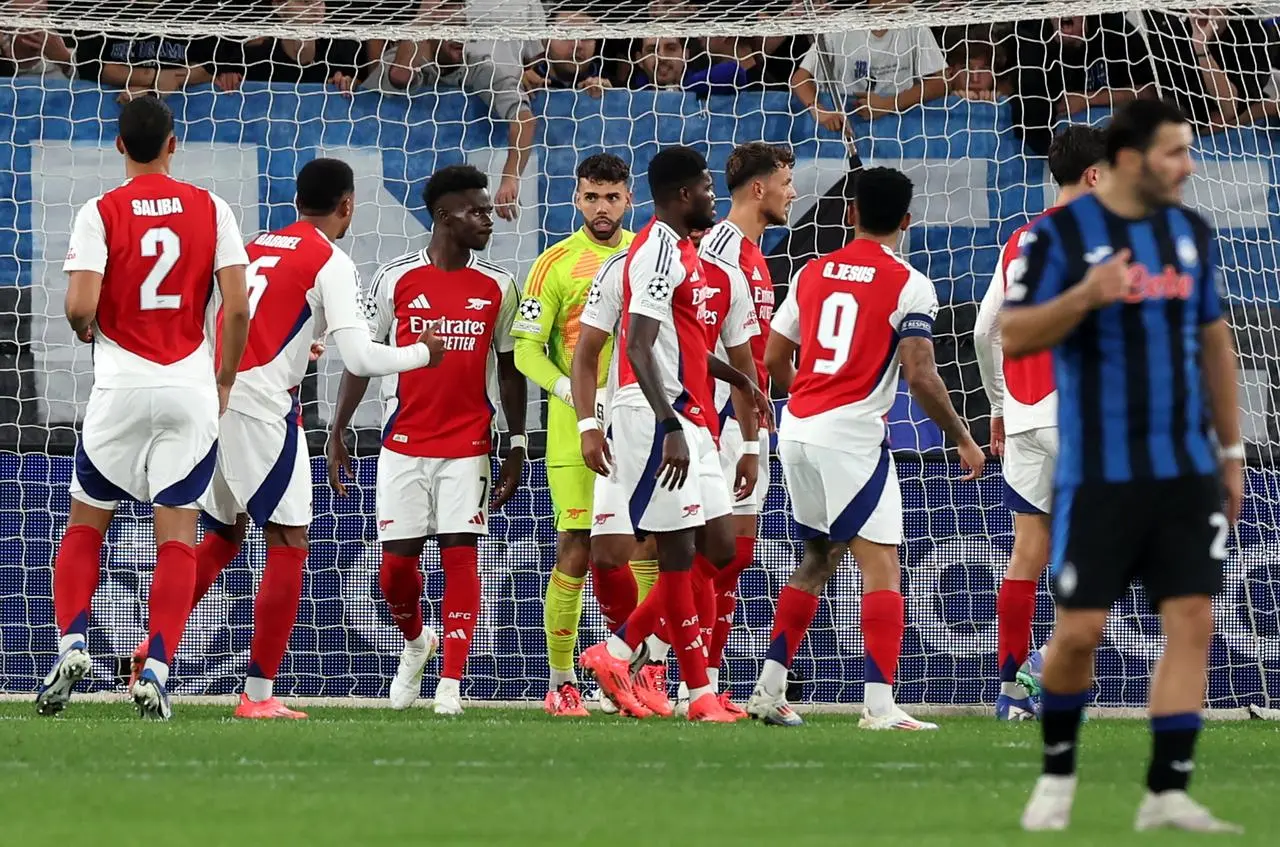 Arsenal goalkeeper David Raya (centre) reacts after saving a penalty