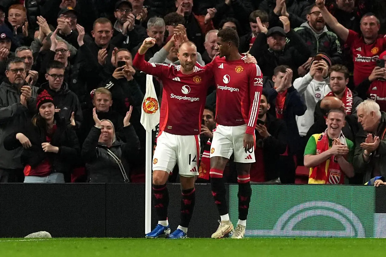 Christian Eriksen, left, celebrates his goal 