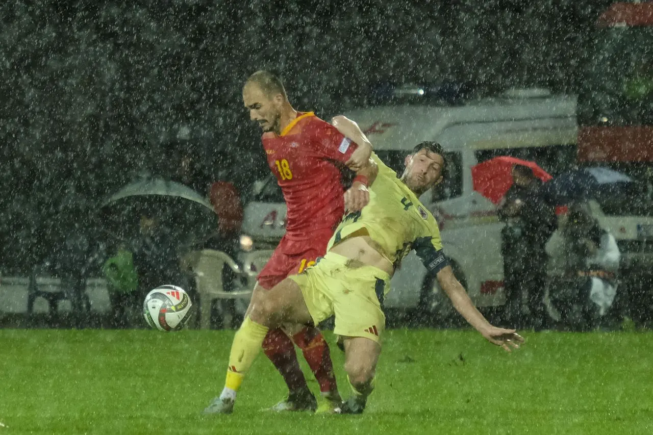 Vladimir Jovovic and Ben Davies battle for the ball