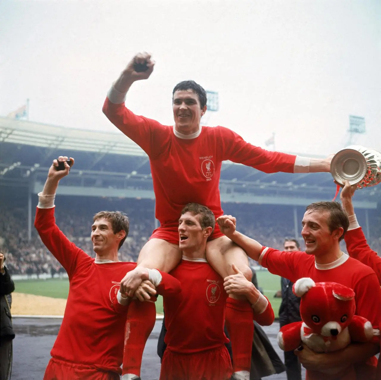 Liverpool’s Ron Yeats (top) is hoisted aloft by team-mates as they celebrate victory in the 1965 FA Cup fina