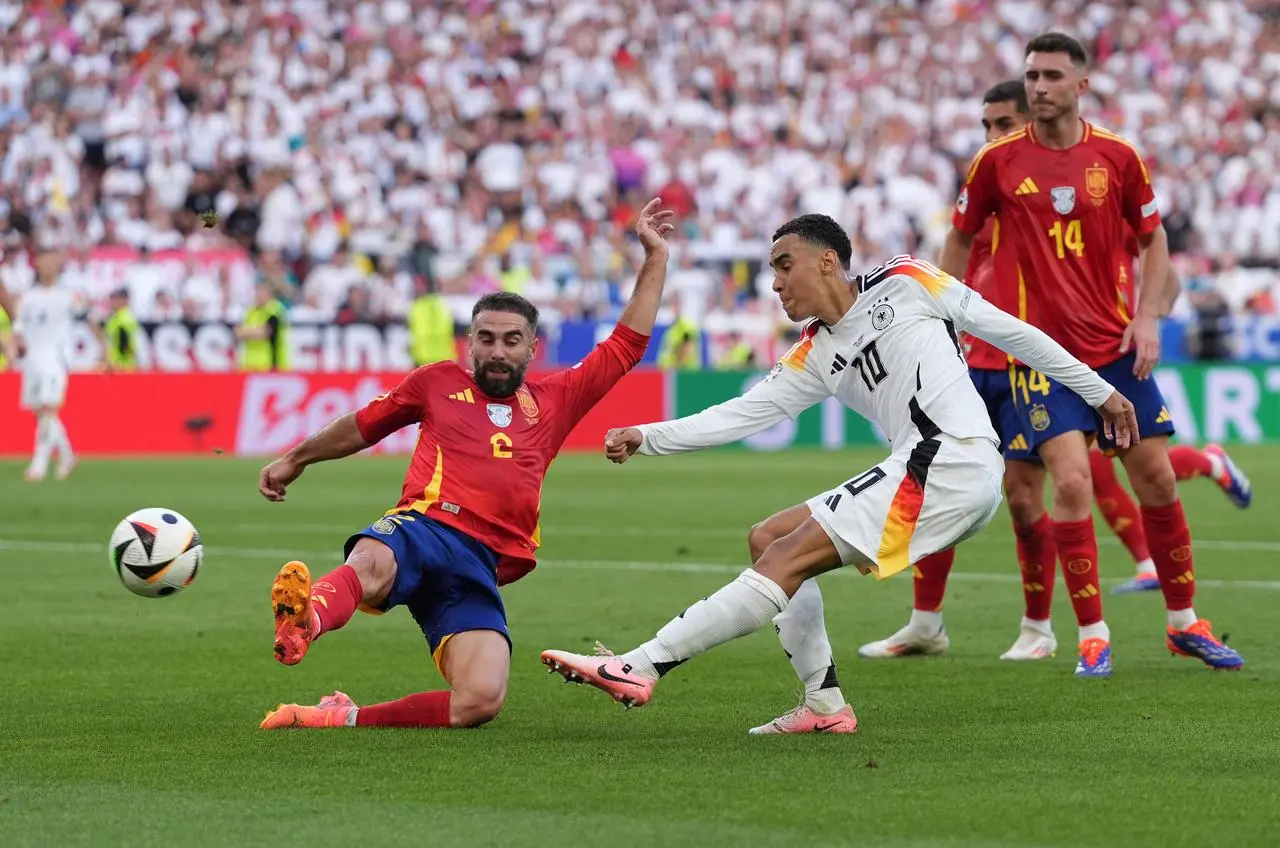 Germany’s Jamal Musiala, left, has a shot against Spain in the Euro 2024 quarter-final