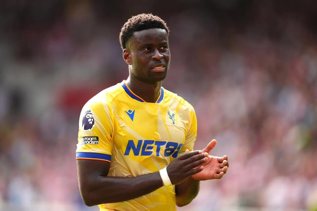 Crystal Palace defender Marc Guehi applauds the fans following defeat at Brentford