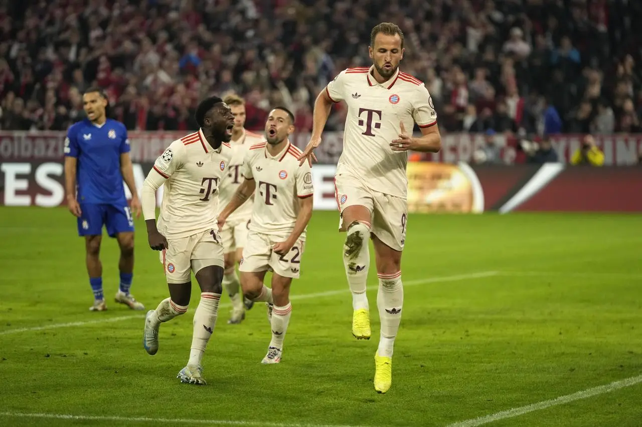 Bayern Munich’s Harry Kane, right, celebrates after scoring his side's fourth goal against Dinamo Zagreb