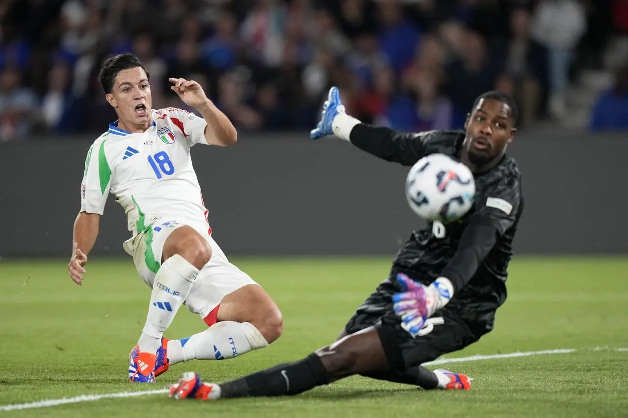 Giacomo Raspadori, left, pokes home Italy's third goal past France goalkeeper Mike Maignan 