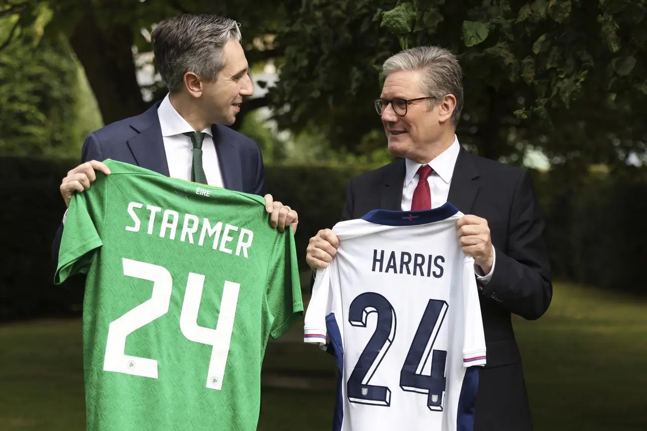 British Prime Minister Sir Keir Starmer, right, and Taoiseach Simon Harris exchange Republic of Ireland and England football shirts with each other's surname on and the number 24