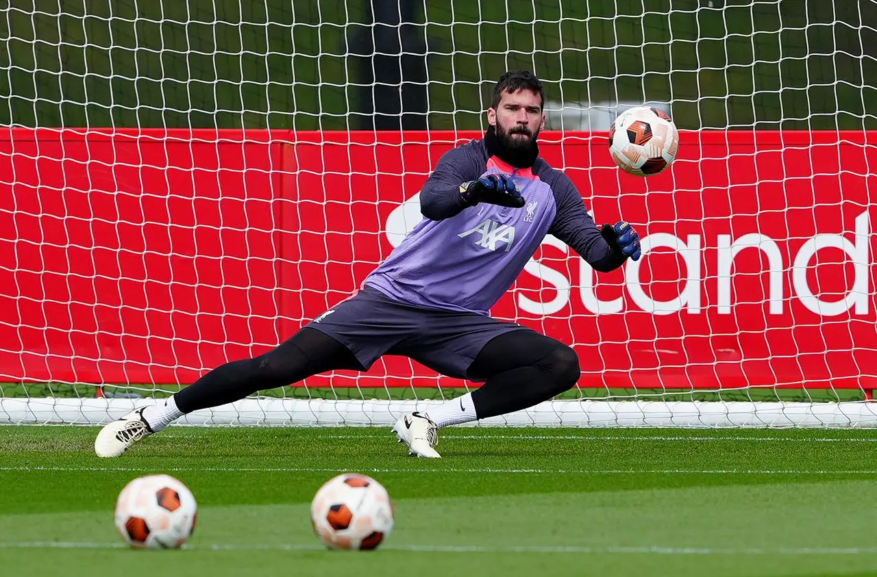 Alisson Becker makes a save in training