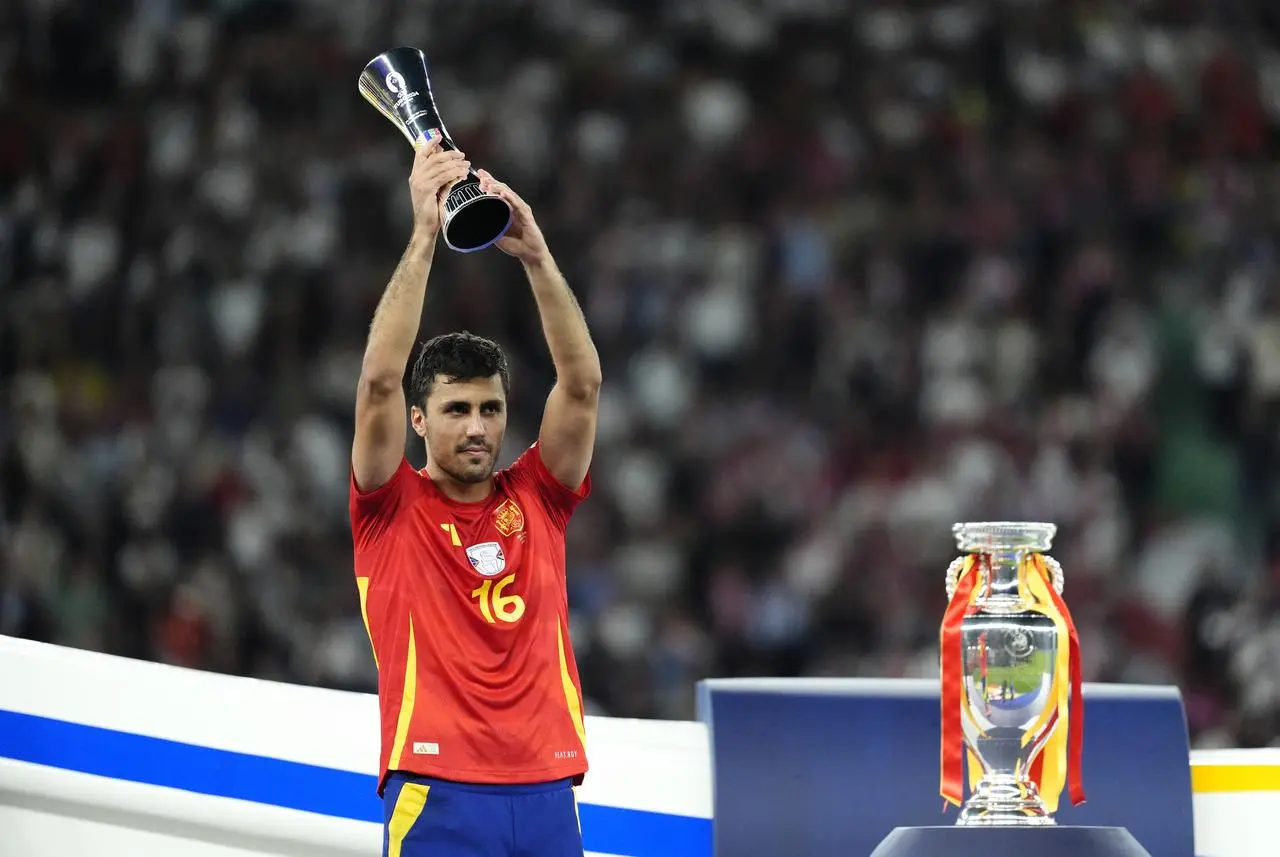 Spain’s Rodri with the Player of the Tournament trophy after winning the UEFA Euro 2024 final 