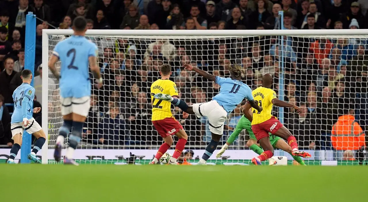 Jeremy Doku, centre right, scores Manchester City’s first goal against Watford