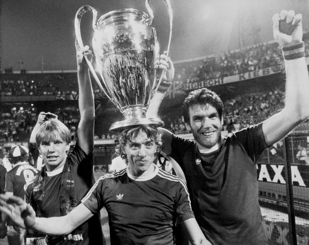 Aston Villa’s Gary Shaw (left), Tony Morley (centre) and scorer of the winning goal Peter Withe (right) proudly show off the cup to the Villa fans in the Feyenoord Stadion. Villa beat Bayern Munich 1-0