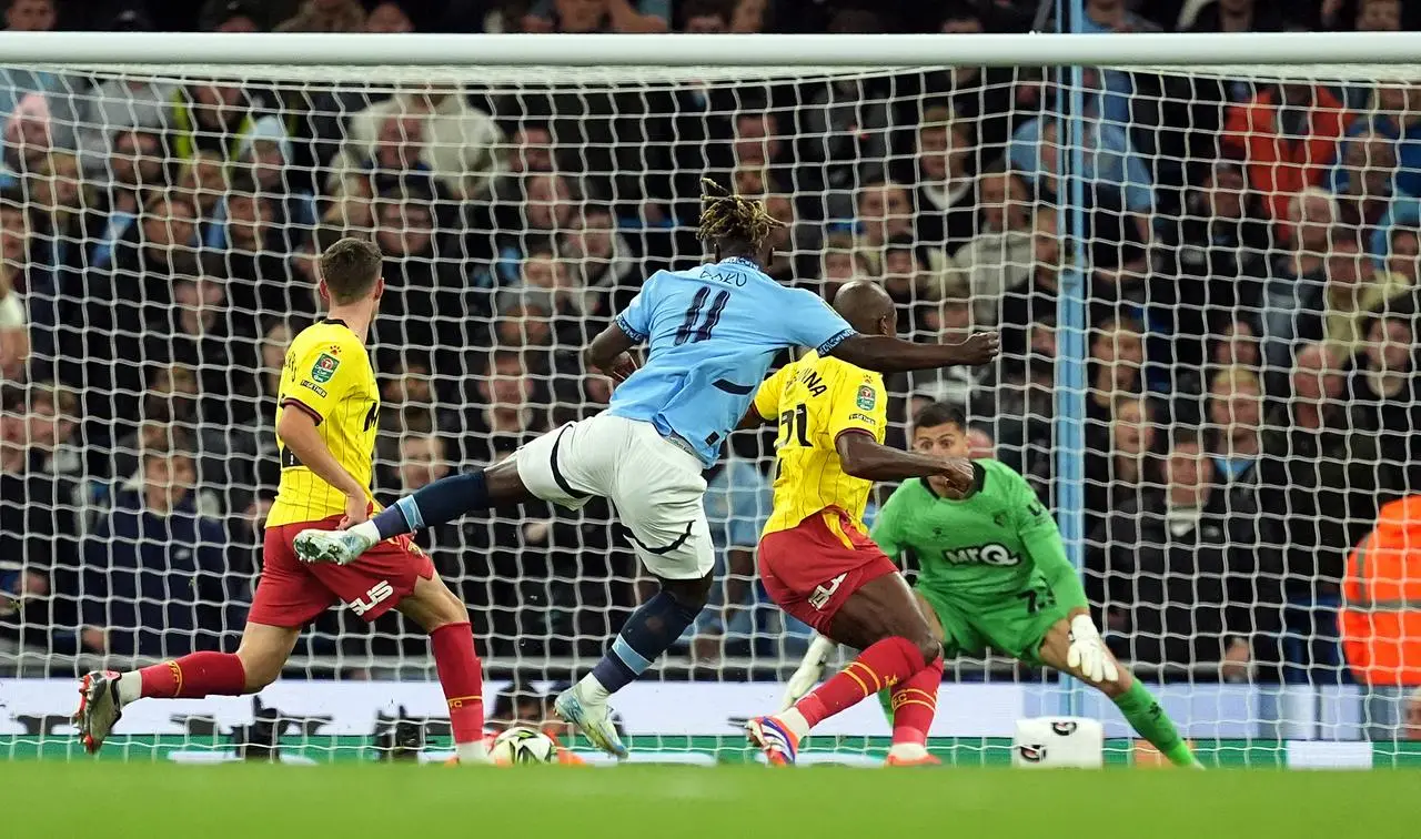 Jeremy Doku, centre, scores Manchester City’s first goal against Watford