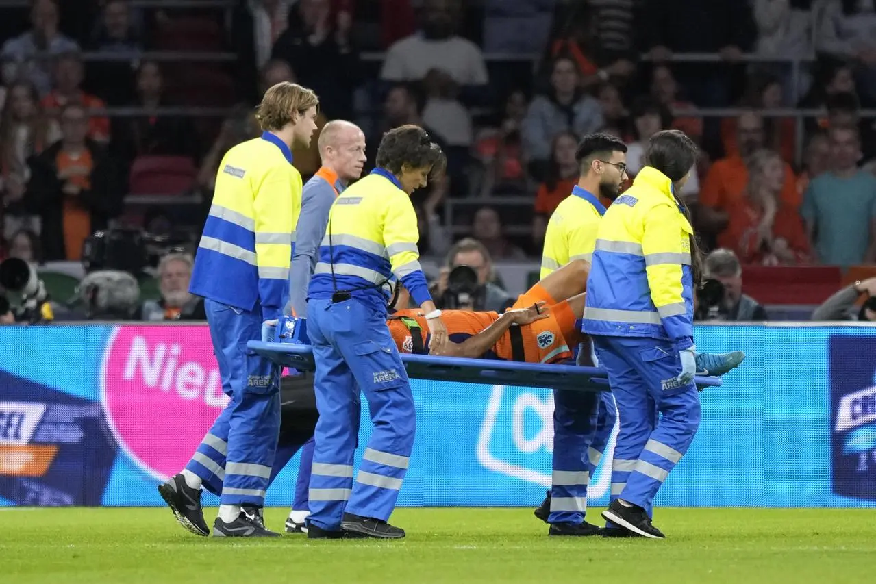 Nathan Ake of the Netherlands is taken off the pitch