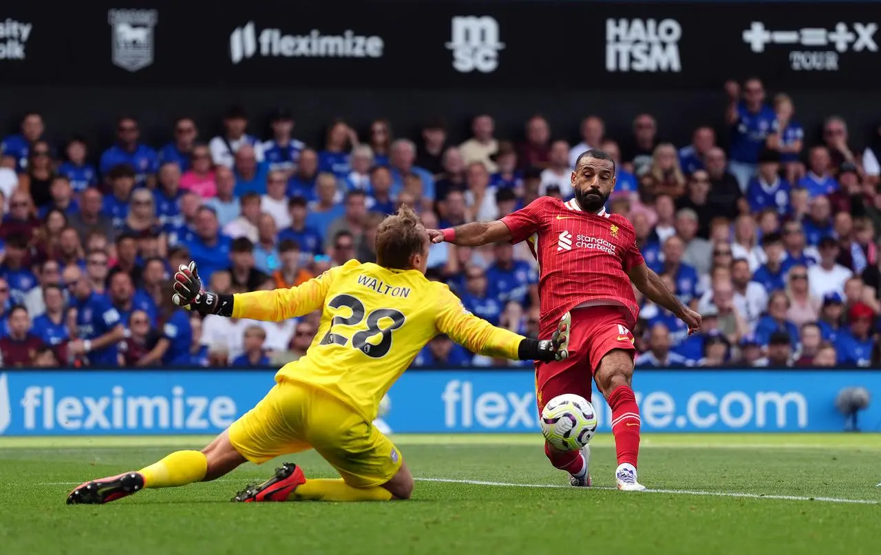 Liverpool forward Mohamed Salah shoots past a diving Christian Walton