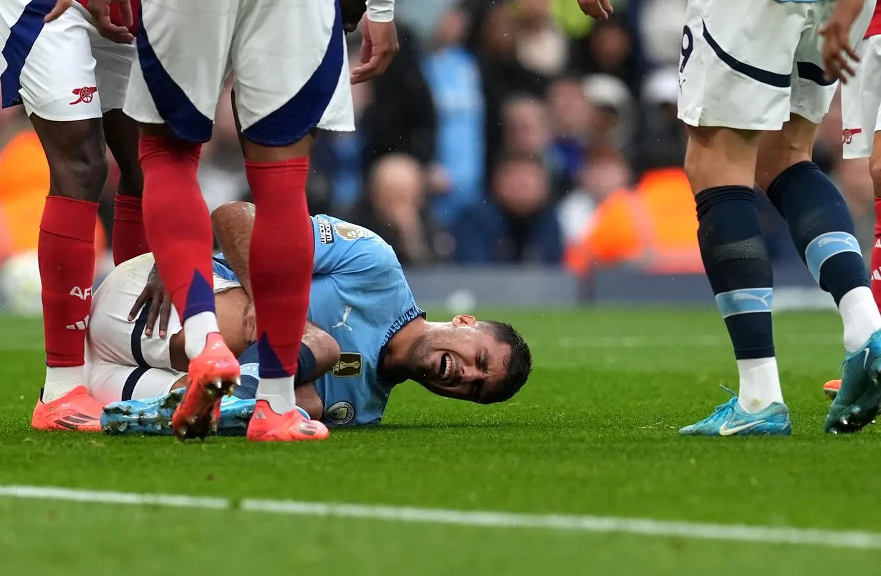 Rodri lies injured during Manchester City's game against Arsenal