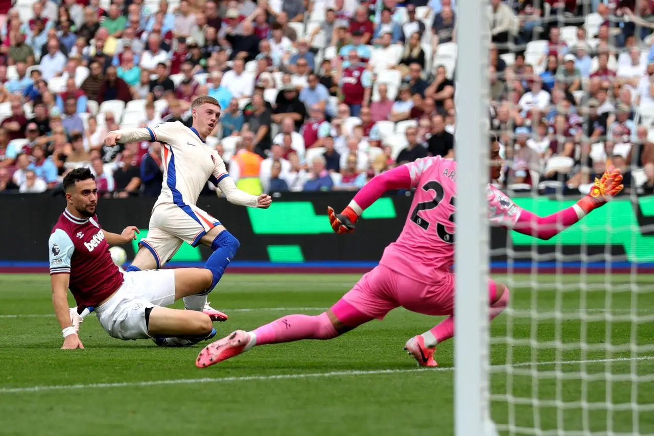 Cole Palmer, centre, scores Chelsea’s third goal against West Ham