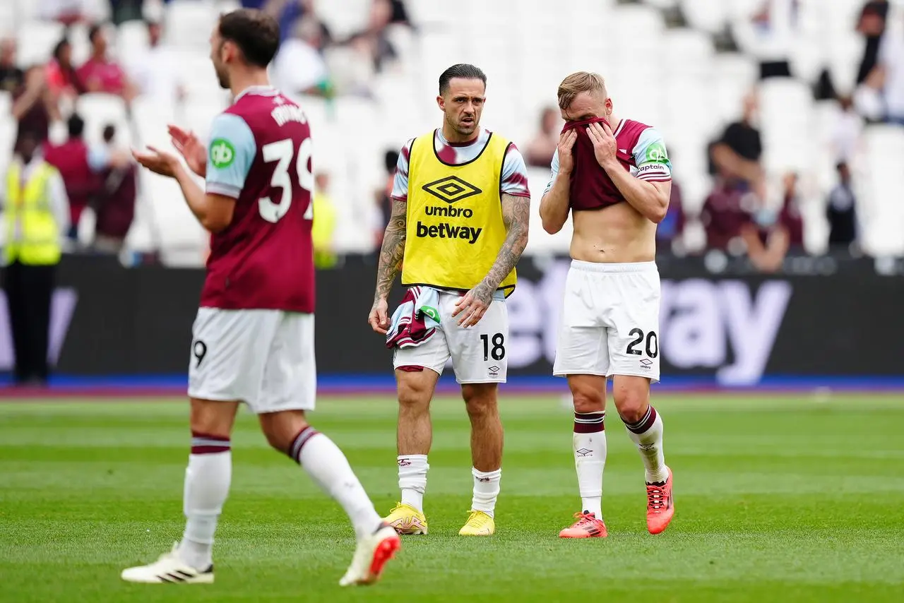 Jarrod Bowen, right, covers his face with his shirt as he and team-mate Danny Ings react to West Ham's loss to Chelsea