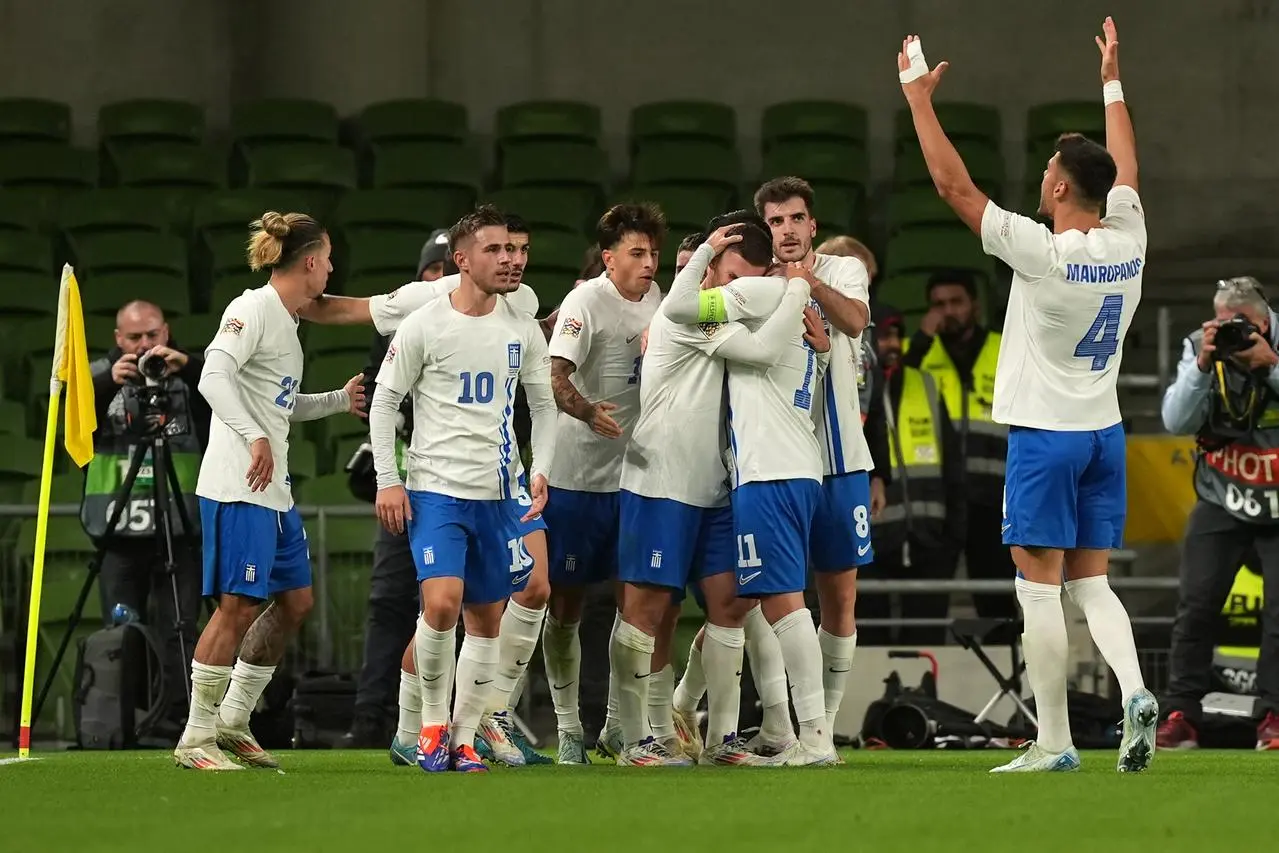 Greece’s Christos Tzolis, centre, celebrates with team-mates after scoring against the Republic of Ireland