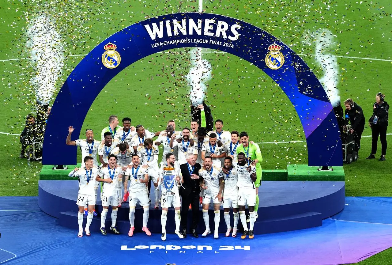 Real Madrid celebrating with the Champions League trophy