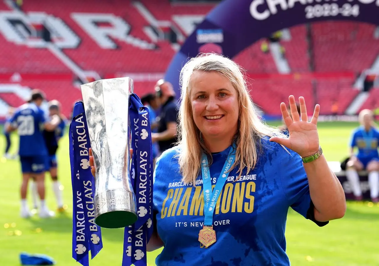 Chelsea manager Emma Hayes raises five fingers as she celebrates with the Women's Super League trophy last season