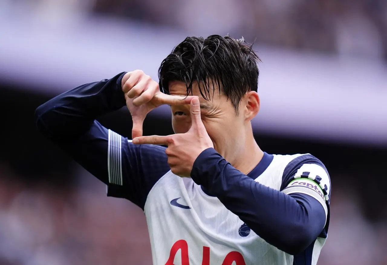 Tottenham's Son Heung-Min celebrates by making a rectangle with his thumbs and forefingers after scoring against Everton