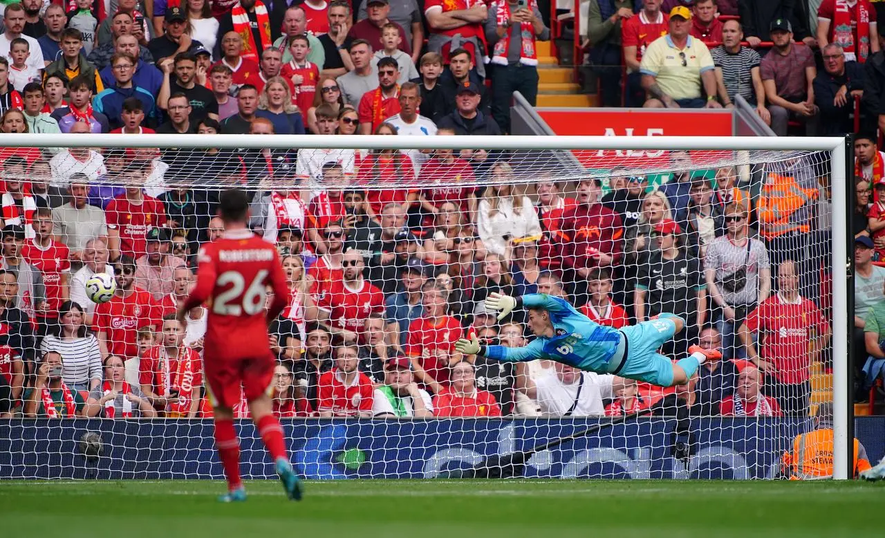 Kepa Arrizabalaga, diving to his right, cannot keep out Darwin Nunez's shot at Anfield