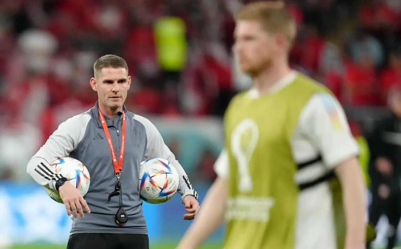 Anthony Barry hold two footballs while overseeing a training session