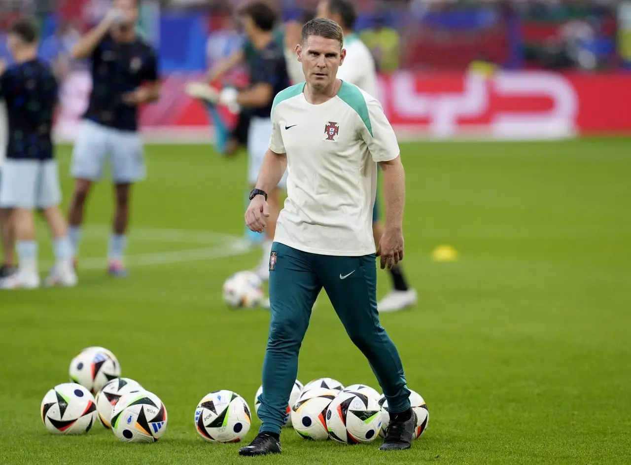 Anthony Barry on the field with footballs prior to a Portugal game