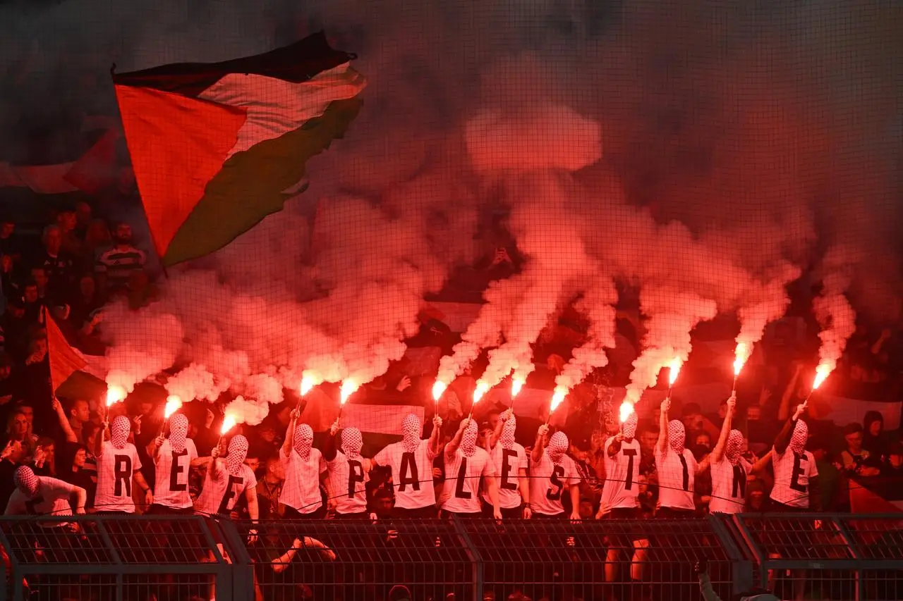 Celtic fans form a 'Free Palestine' display with flares in Dortmund