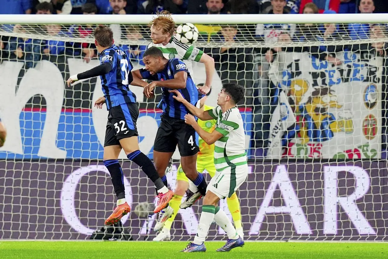 Isak Hien, centre, challenges for a header in the box