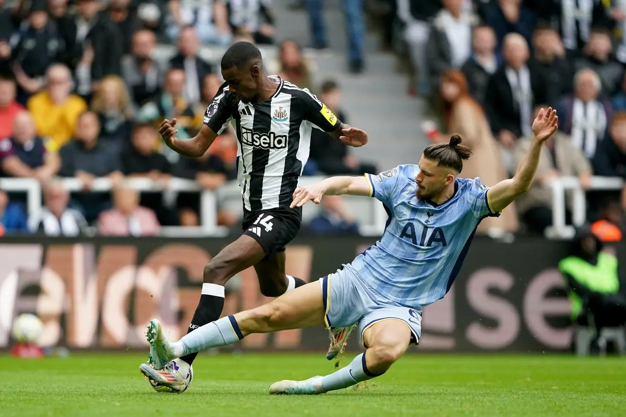 Newcastle's Alexander Isak battles for possession with Tottenham's Radu Dragusin