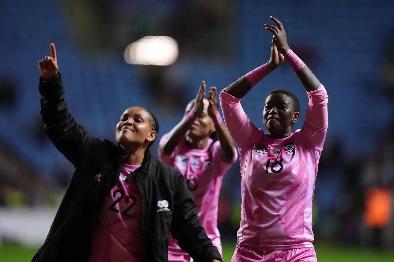 South Africa’s Sibulele Holweni, right, and Amogelang Motau enjoy the post-match atmosphere in front of their fans