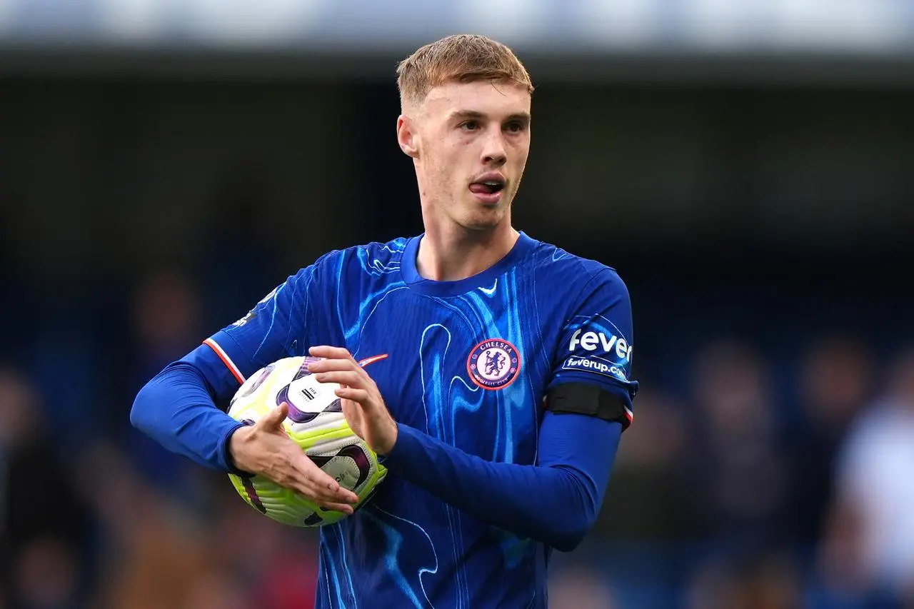 Chelsea’s Cole Palmer celebrates with the match ball after scoring four goals against Brighton