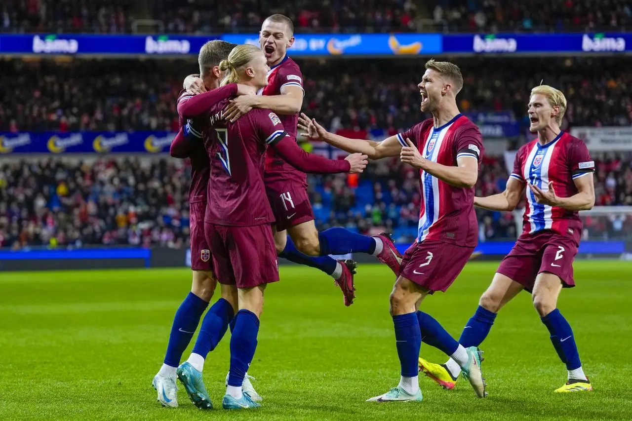 Erling Haaland, left, celebrates with team-mates