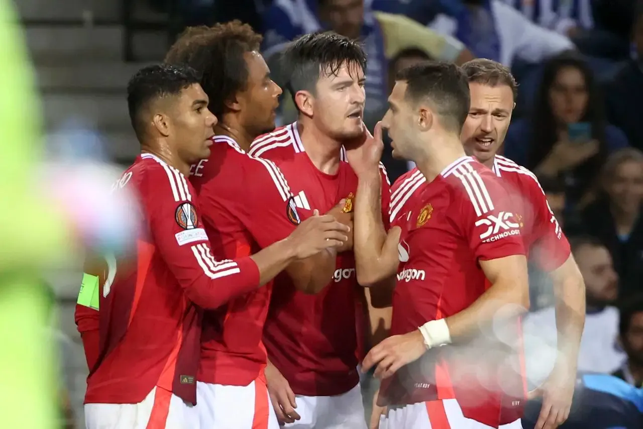 Harry Maguire, centre, celebrates his equaliser against Porto