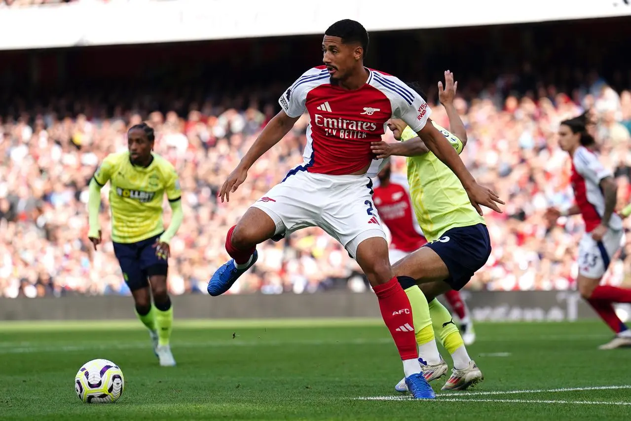 Arsenal’s William Saliba and Southampton’s Yukinari Sugawara (right) battle for the ball