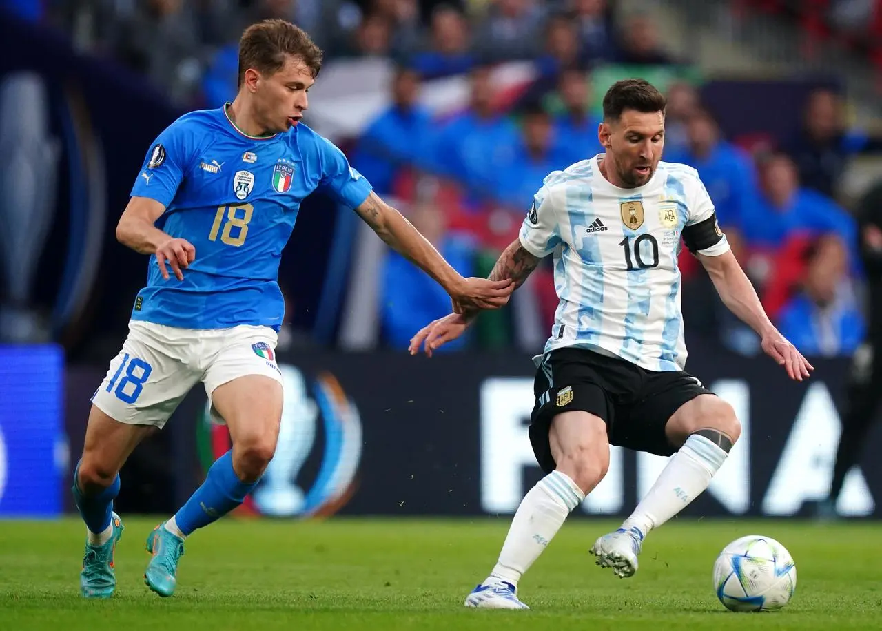 Italy midfielder Nicolo Barella battles with Argentina playmaker Lionel Messi for the ball