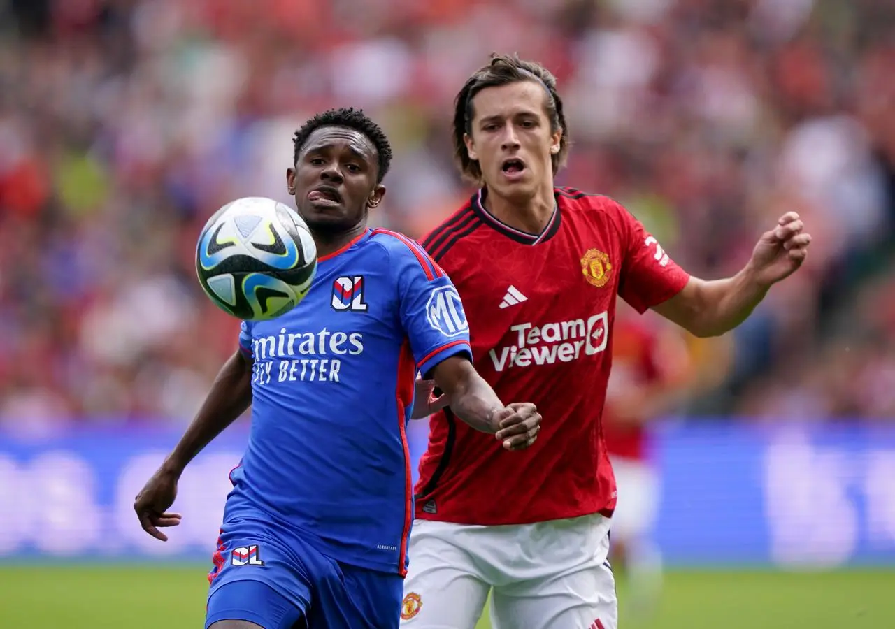 Manchester United’s Alvaro Fernandez and Lyon’s Jeffinho battle for the ball 