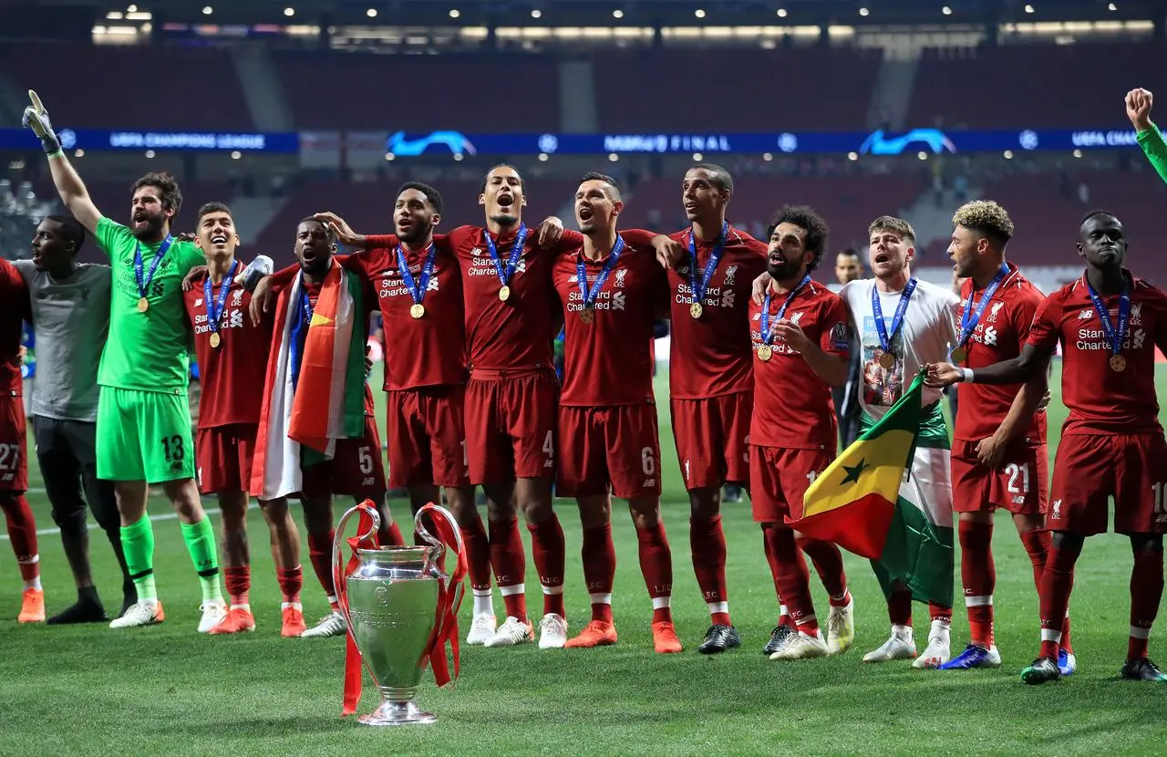 Liverpool players celebrating with the Champions League trophy