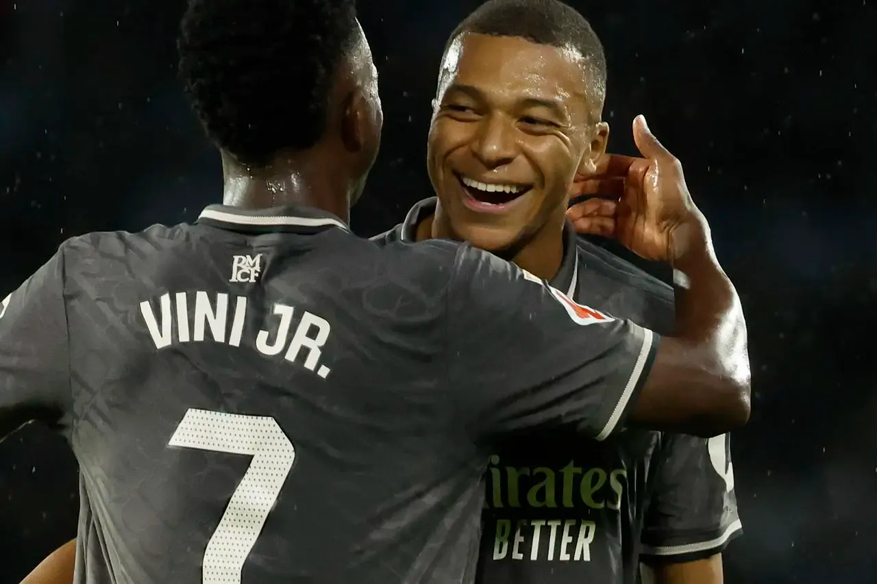 eal Madrid’s Kylian Mbappe, right, celebrates with Vinicius Junior after scoring the opening goal against Celta Vigo