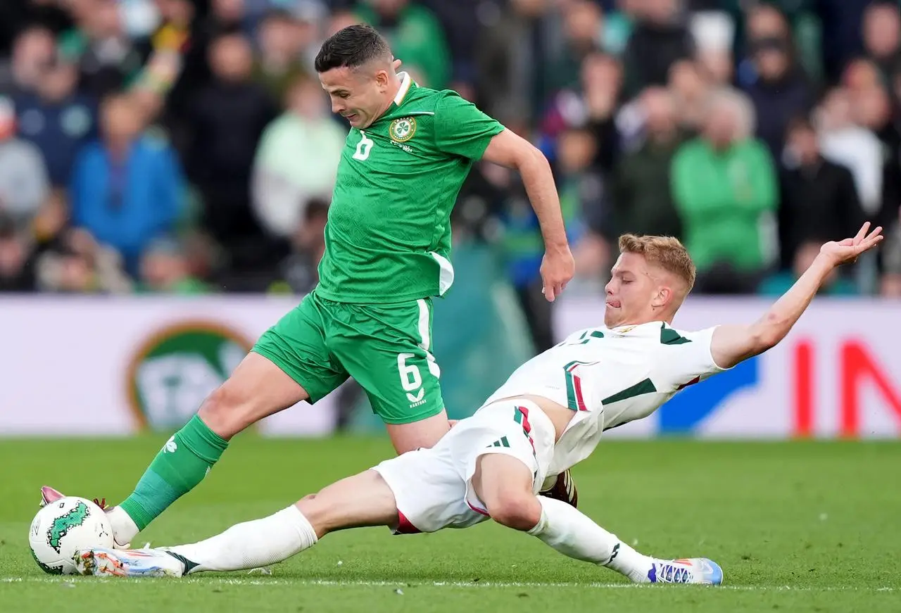 Republic of Ireland’s Josh Cullen (left) and Hungary’s Andras Schafer battle for the ball