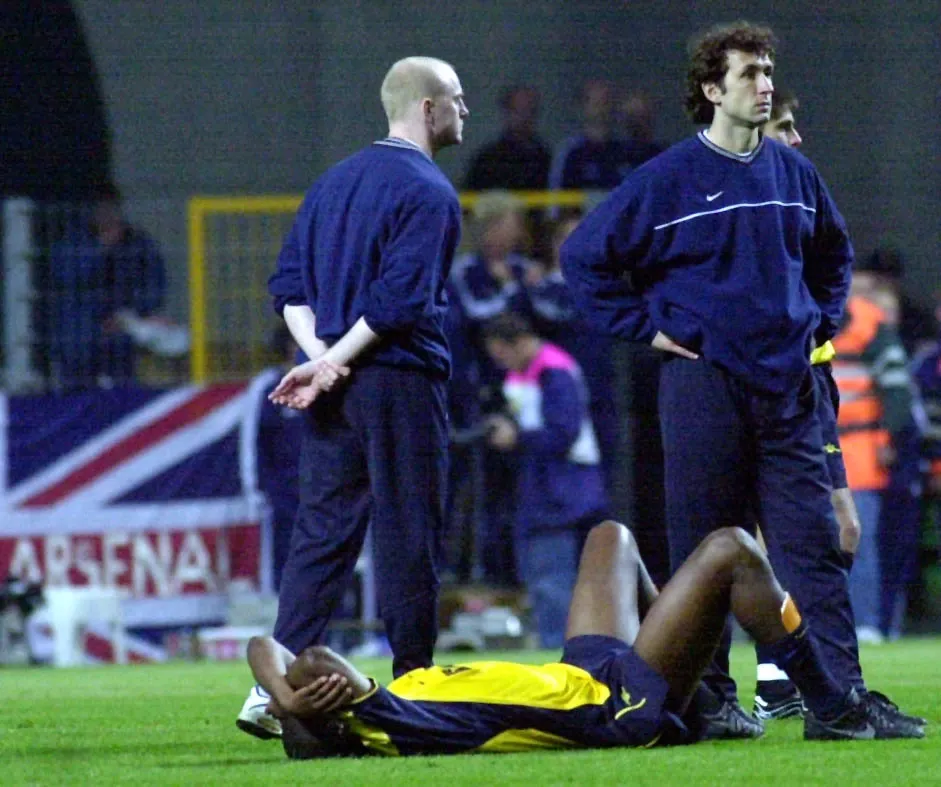 Patrick Vieira lies on the floor and covers his face 